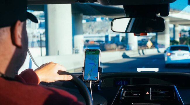 man driving with gps on phone