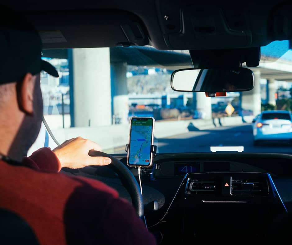 man driving with gps on phone