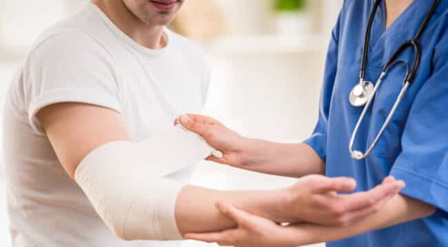 nurse bandaging arm