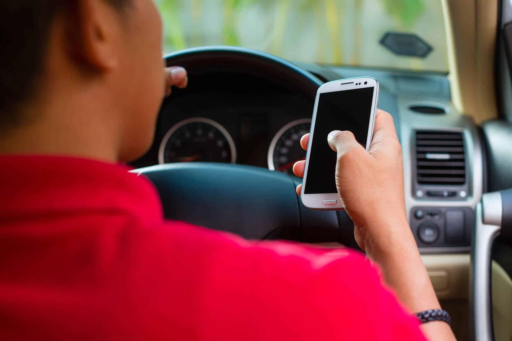 man driving while on phone