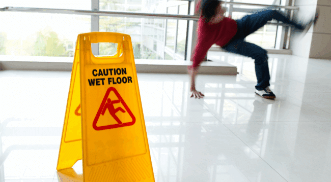 slip and fall sign with man falling in background