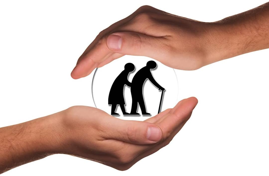 hands holding elderly icon